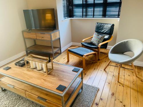 a living room with two chairs and a table at 16 St Martins near to Steep Hill in Lincoln