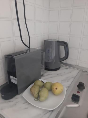 a plate of potatoes on a counter next to a blender at Kis-Kis in Metókhion Ayías Kiriakís