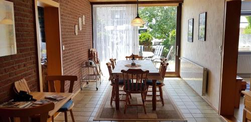 una sala da pranzo con tavolo e sedie di Ferienwohnung-Floppy-Hansi-Fewo-4-EG a Sankt Peter-Ording