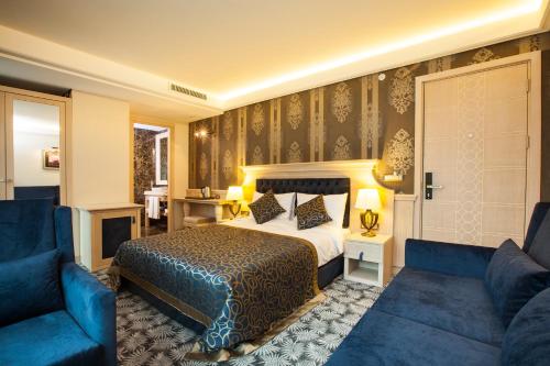 a hotel room with a bed and a couch at The Conforium Hotel İstanbul in Istanbul