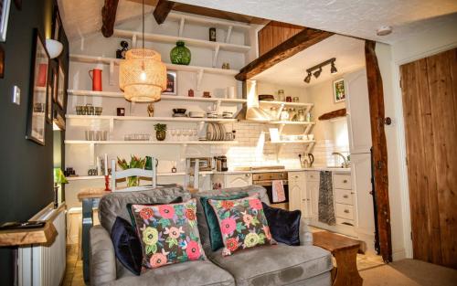 a living room with a couch and a kitchen at The Folly in Sedbergh