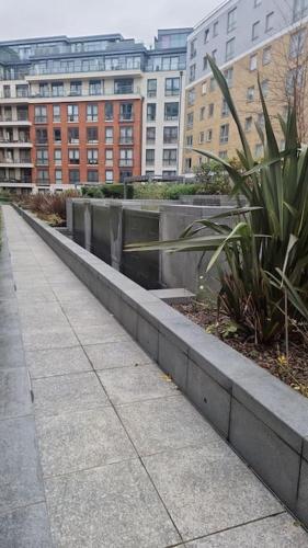 a sidewalk in a city with buildings in the background at Charming Manhatten studio Apartment Chelsea in London