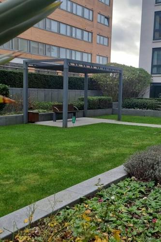 a garden with a gazebo in front of a building at Charming Manhatten studio Apartment Chelsea in London