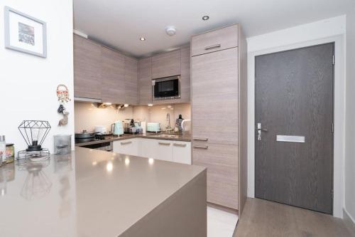 a large kitchen with a large white counter top at Charming Manhatten studio Apartment Chelsea in London