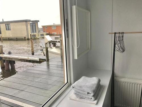 a bathroom with a window with a view of a dock at Quiet Waterloft near Amsterdam and Schiphol WS11 in Aalsmeer