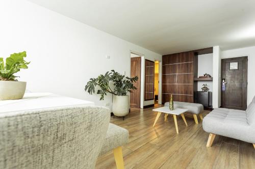 a living room with a couch and a chair at Hotel Carretero in Manizales
