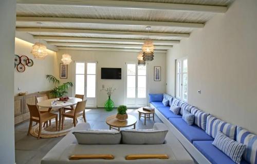 a living room with a blue couch and a table at NESEA Boutique Apartments in Hydra