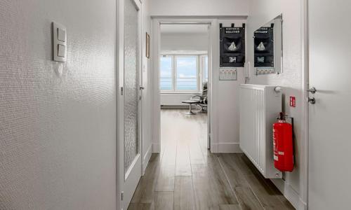 a hallway with a red fire hydrant in a room at BAUDOIN 05.03 in De Panne