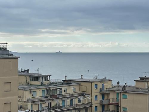a view of the ocean from the roofs of buildings at Colombo 1935 - Apartments in Follonica