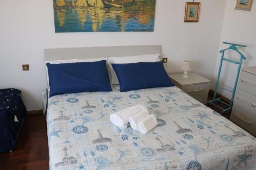 a bedroom with a bed with two towels on it at ROSSINI APARTMENT FRONTE MARE in Follonica