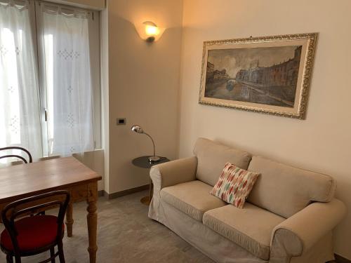 a living room with a couch and a table at PAVIA CENTRO in Pavia