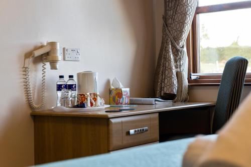 a desk in a room with a window at Tollyrose Country House in Newcastle