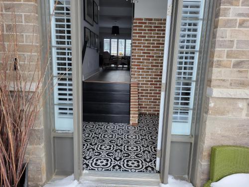 a door leading to a hallway with a tile floor at Exclusive Townhome near West-Side Trails in Waterloo