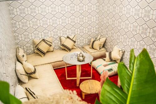a living room with a couch and a table at Riad Fz Marrakech in Marrakech