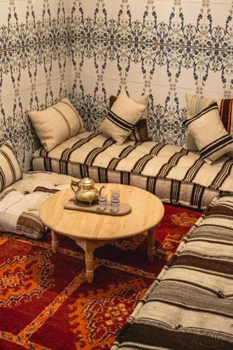 a living room with two couches and a coffee table at Riad Fz Marrakech in Marrakech