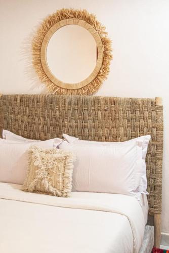 a bedroom with a bed with a mirror above it at Riad Fz Marrakech in Marrakech