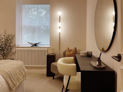a bedroom with a desk and a chair and a mirror at Luxury 2 Bedroom Flat in Central Todmorden in Todmorden