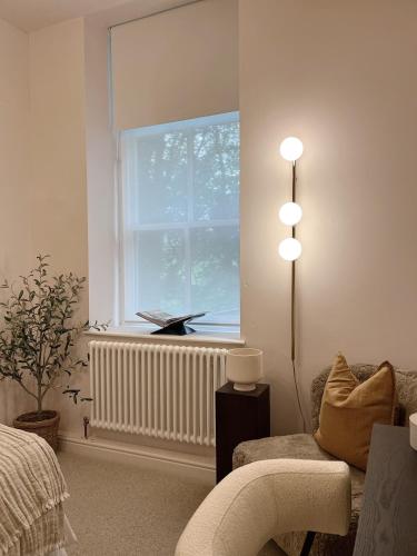 a living room with a couch and a window at Luxury 2 Bedroom Flat in Central Todmorden in Todmorden