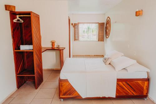 a bedroom with a bed and a book shelf at Villa Baleia 