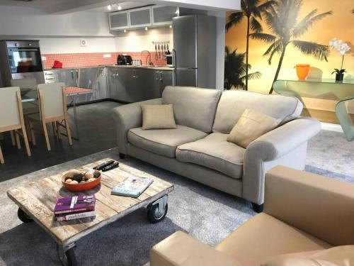 a living room with a couch and a coffee table at Modern Apartment in Latitude52 Dockyard & parking in Plymouth
