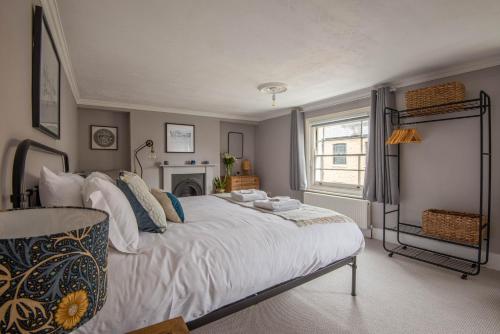 a bedroom with a large white bed and a window at The Broadstairs Townhouse in Broadstairs