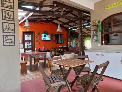 a kitchen and dining room with a table and chairs at Floripa Beach House Hostel in Florianópolis