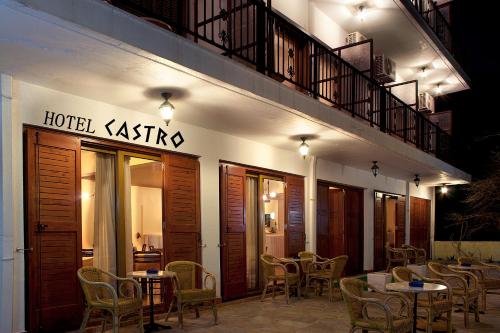 a restaurant with tables and chairs in front of a building at Castro Hotel in Monemvasia