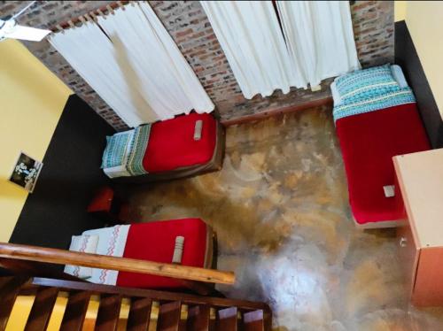 a group of red chairs sitting on top of a staircase at Hotel Village del Sol in Puerto Iguazú