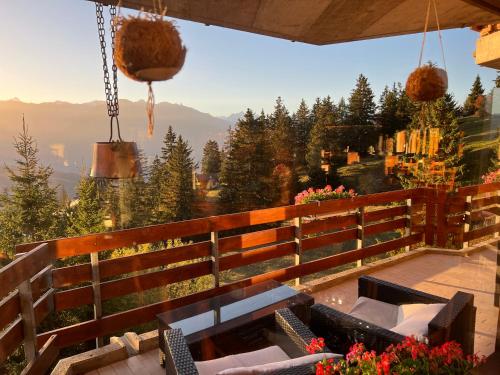 a balcony with chairs and a view of the mountains at Eden Resort Anzère in Anzère