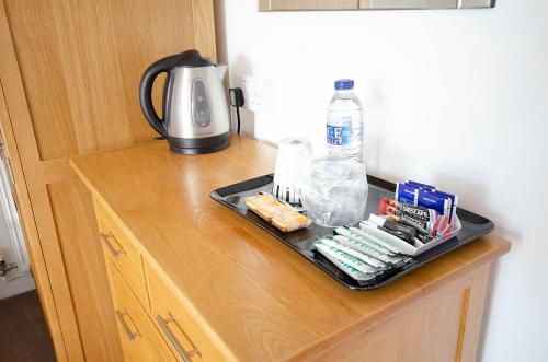 a tray of food and a coffee maker on a counter at Headlands - Room Only Accommodation in Falmouth