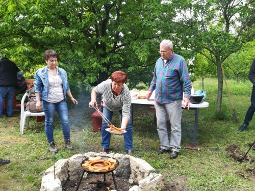 a group of people standing around a fire pit at Valéria in Budakalász