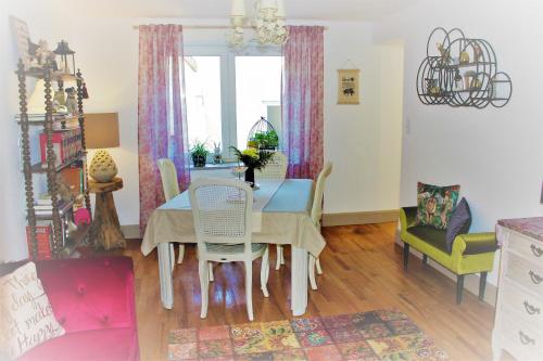 a dining room with a table and chairs at Fairytale Memories SPAS Privatifs in Varsberg