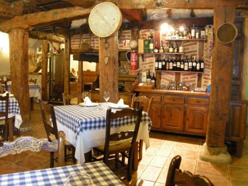 a dining room with a table and a bar at La Posada de Carmen in Chañe