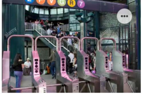 a view of a subway station with people on escalators at Entire Bubbly Queens Apartment 5 mins from LaGuardia 1 min from train in Queens