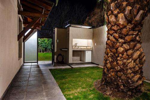a courtyard of a house with a stone pillar at Chacras Wineland Lodge - Casa West in Ciudad Lujan de Cuyo