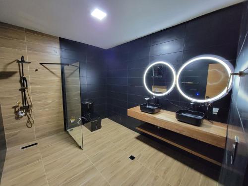 a bathroom with a shower and two sinks and mirrors at Luxury Tropical Paradise Villa 4B Heated Pool in Camú