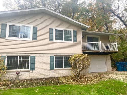 a house with a porch and a balcony at The House Hotels- E. Turkeyfoot #1 in Akron