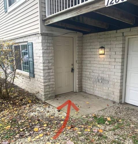 a house with an orange arrow in front of a door at The House Hotels- E. Turkeyfoot #1 in Akron