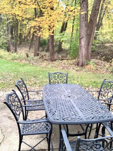 a black table and chairs sitting next to a park at The House Hotels- E. Turkeyfoot #1 in Akron