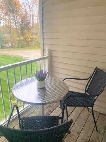 a table and two chairs on a porch at The House Hotels- E. Turkeyfoot #1 in Akron