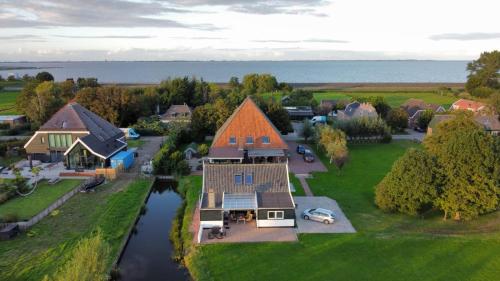 an aerial view of a house with a river at vakantiehuis Warder in Warder