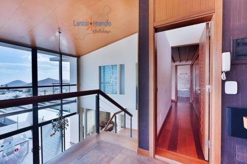 a hallway of a house with a balcony at Vivienda Vacacional Casa Erizo adults only in Nazaret