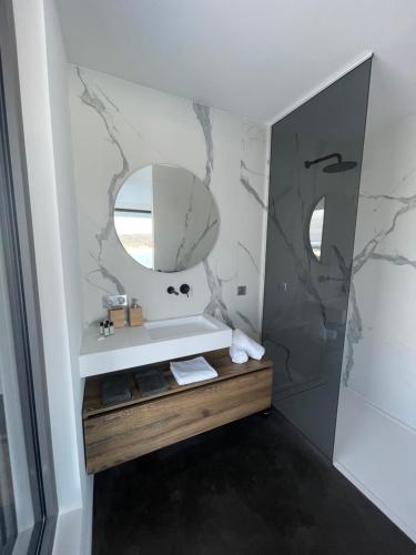 a bathroom with a sink and a mirror at Le Nordic in Grande Riviere