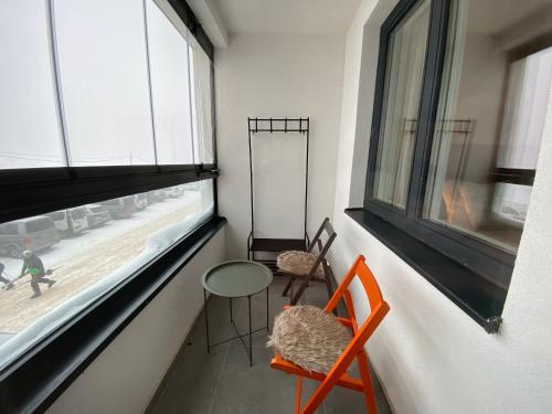a room with a table and two chairs and a window at Zen Apartments Jahorina - Snježna Dolina Resort in Jahorina