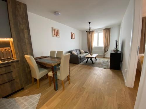a living room with a table and a couch at Zen Apartments Jahorina - Snježna Dolina Resort in Jahorina