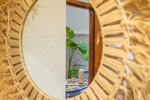 a mirror reflection of a table in a room at Riad Fz Marrakech in Marrakech