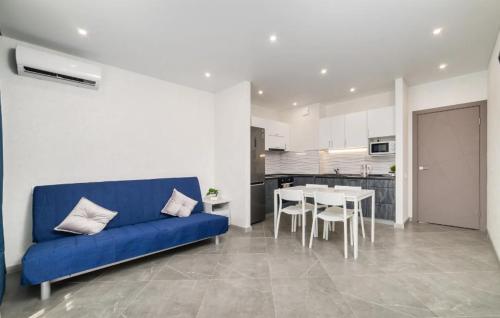 a living room with a blue couch and a table at Two-roomed flat 68м2 in Tbilisi City