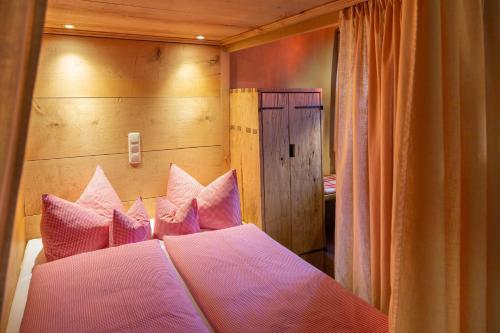 a bedroom with a bed with pink pillows at Turm zu Schloss Schedling in Trostberg an der Alz