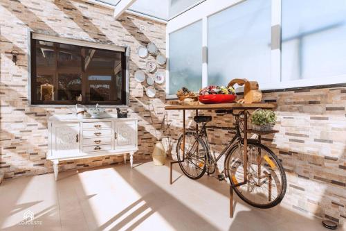 a bike parked in a room with a stone wall at Casa do Pátio - 3 Bedrooms, Ponte Rol in Torres Vedras