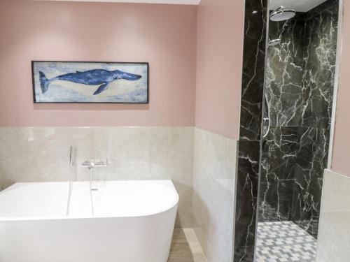 a bathroom with a whale painting on the wall at Pengwern Bach in Llanrwst